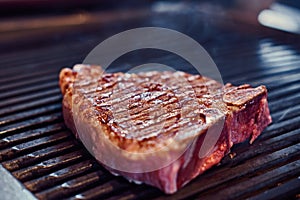 Close-up photo of roasted juicy steak on the grill