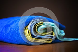 close up photo of rolled stack of colorful towels b