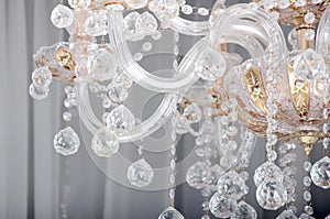 Close-up photo of the scenery on the old chandelier. Glass figures shine and reflect light with their faces