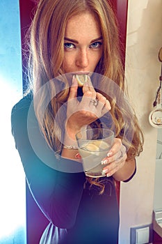 Close up photo of sensual woman with lemon and cocktail