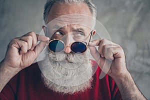 Close up photo of serious dreamy old man touch his blue specs look chic elegant have x-mas time wear stylish pullover