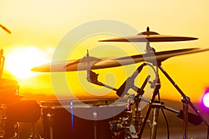 Close up photo of set drums on rooftop at sunset time