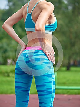 Close up photo of shapely woman's buttocks in color shorts