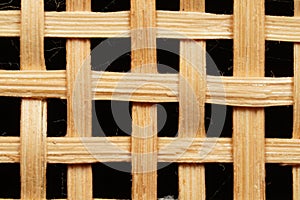 Close-up photo of a small bamboo weave, featuring a loose lattice pattern with open gaps.