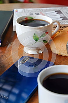 Close-up photo of someone drinking tea in the front yard of his house