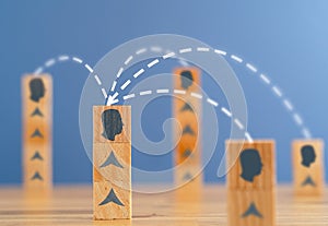 Close up photo of stacked wooden blocks with person silhouette linked to eachother