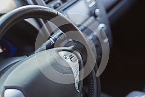 Close-up photo of the steering wheel of a modern electric car