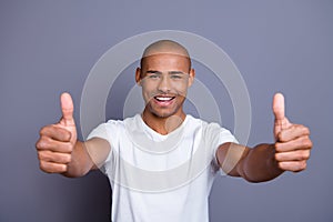 Close up photo strong healthy teeth dark skin he him his guy bald head approve show thumbs fingers up advise buy buyer