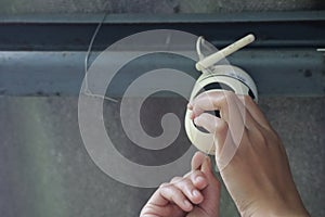 Close-up photo of the technician holding a CCTV camera to install an internet system for installing a CCTV camera at home