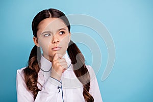 Close up photo of thoughtful kid have dilemma difficult test touch chin wear white blouse isolated over blue background