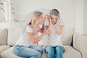 Close up photo two people mom teen daughter hands arms head not listen mum lecture eyes closed terrible noise pain wear