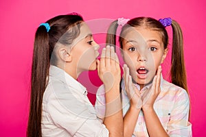 Close up photo two small little age girls tell talk speak in ear novelty about school homework pupils wearing casual