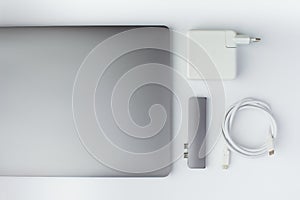 Close-up photo of type-c hub, charger, cable and laptop