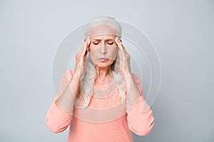 Close up photo of upset exhausted old lady suffering from strong headache reaction on magnetic storm and weather