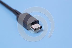 Close up photo of usb type c connector on blue blurred background