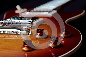 Close Up Photo of Volume and Tone Controls of Electric Guitar