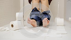 close up photo woman with constipation or diarrhoea sitting on toilet with her pants