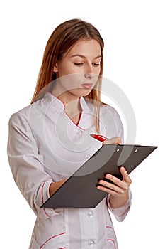 Close-up photo of a woman doctor in a white coat. The doctor monitors the records of the medical history, drugs