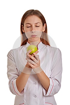 Close-up photo of a woman doctor in a white coat. The doctor monitors the records of the medical history, drugs and the