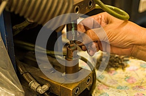 Close-up photo of woman`s hand electronically welding a part photo