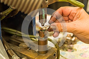 Close-up photo of woman`s hand electronically welding a part photo