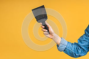 Close-up photo of woman's hand holding a spatula tool