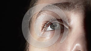 Close-up photo of young woman using eye drops