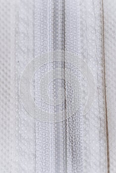 It is a close up photo of zipper white