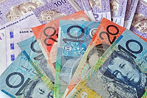 Close-up photograph of Australian dollars and Malaysia's ringgit Malaysia
