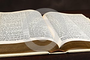 Close-up Photograph of Open Old Bible On Brown