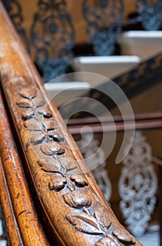 Close up photograph showing detail on the carved wooden handrail of the sweeping staircase at The Grand Hotel, Brighton, UK