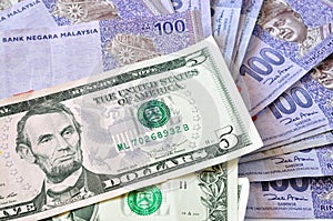 Close-up photograph of United States dollars and Malaysia's ringgit malaysia