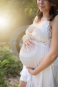 Close up photograph of young women 9 months along pregnant belly