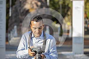 Close-up of a photographer reviewing the photographs on his camera