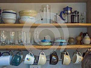 Close-up photography of a kitchen shelf with cups, glasses, bowls