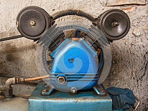 Close-up photography of the very used engine of an air compressor