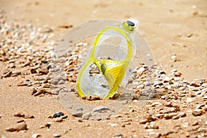 Close up photography of yellow snorkling mask standing in the sand.Underwater diving concept