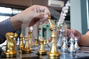 Close-up photos of checkmate hands on a chessboard during a chess game The concept of business victory strategy wins the intellige