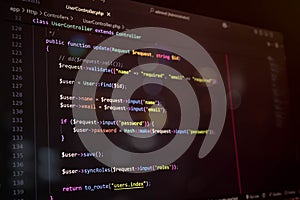 Close-up of PHP Laravel code on a dark editor screen, showcasing user update function and password hashing. Ideal for programming