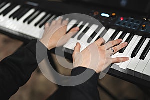 close-up of a pianist's hands while playing the piano