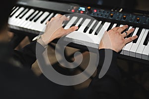 close-up of a pianist's hands while playing the piano