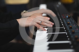 close-up of a pianist's hands while playing the piano