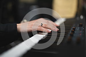 close-up of a pianist's hands while playing the piano