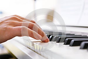 Close up of pianists hand playing piano. Shallow deep of field.