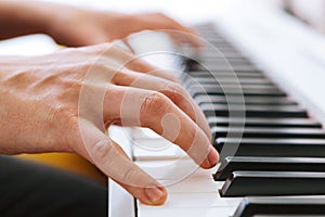 Close up of pianists hand playing piano. Shallow deep of field.