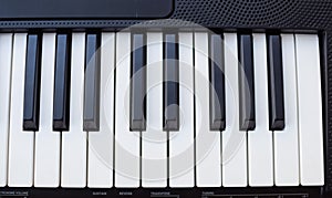 Close-up of piano keys. Piano black and white keys and Piano keyboard musical instrument placed at the home balcony during sunny