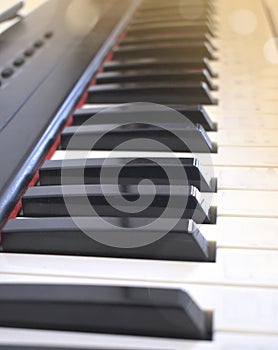 Close up piano keys on sunset light. Classic, jazz or electronical music concept.