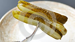 a close up of a pickle on a plate with tomatoes