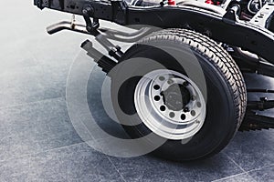 Close up pickup truck rear tire with car chassis underbody photo