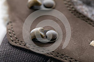 close-up picture of brass shoe hooks. Detail of trekking shoes hook and loop for strap